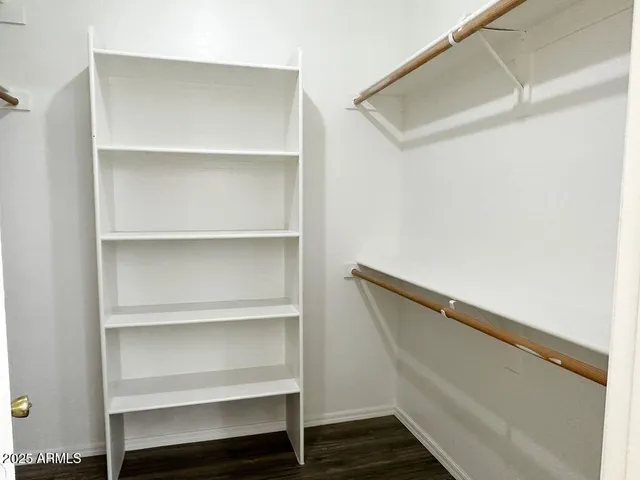 a view of walk in closet with empty racks