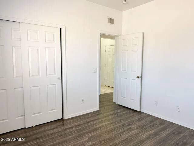 a view of a room with wooden floor