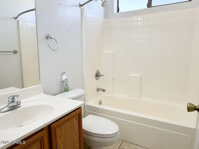 a bathroom with a sink toilet vanity and shower