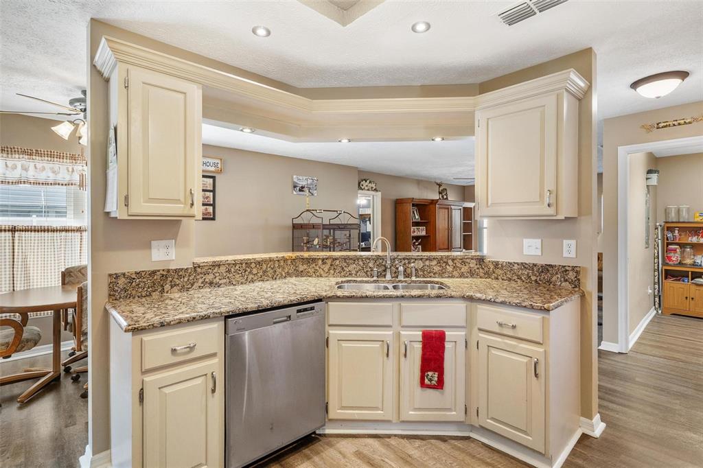 450 Northeast 55th Street Ocala, FL 34479 - Photo 16 of 68 a kitchen with granite countertop a sink stove and cabinets