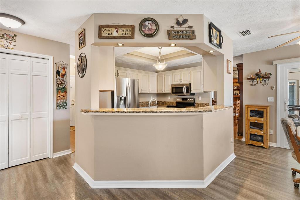 450 Northeast 55th Street Ocala, FL 34479 - Photo 18 of 68 a view of a kitchen with furniture and wooden floor