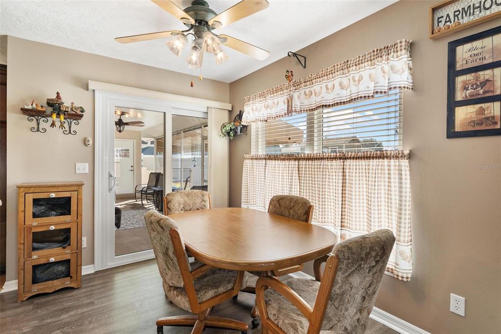 450 Northeast 55th Street Ocala, FL 34479 - Photo 19 of 68 a view of a dining room with furniture and wooden floor