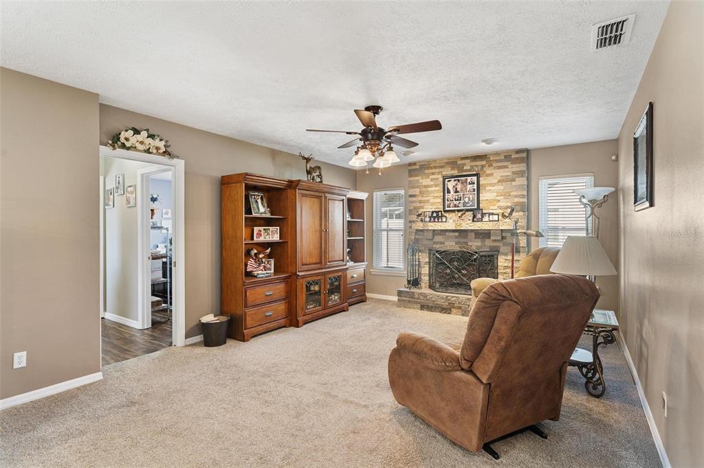 450 Northeast 55th Street Ocala, FL 34479 - Photo 20 of 68 a living room with furniture a ceiling fan and a flat screen tv