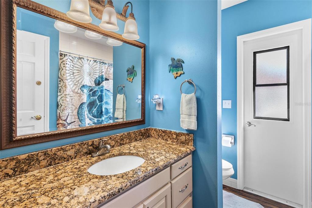 450 Northeast 55th Street Ocala, FL 34479 - Photo 33 of 68 a bathroom with a granite countertop sink and a mirror