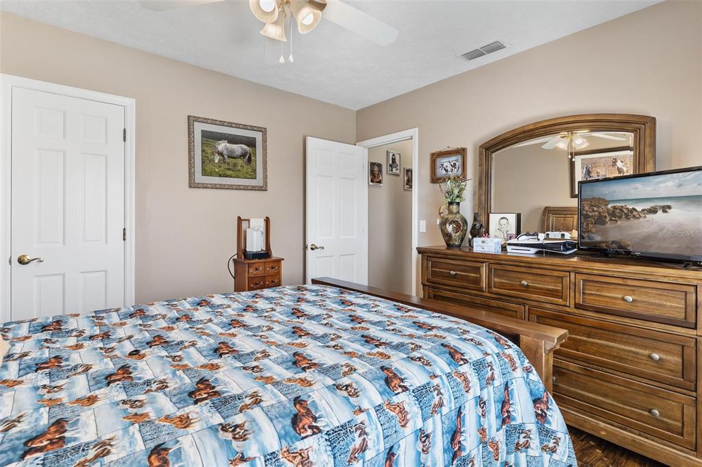 450 Northeast 55th Street Ocala, FL 34479 - Photo 36 of 68 a bedroom with a bed and a dresser