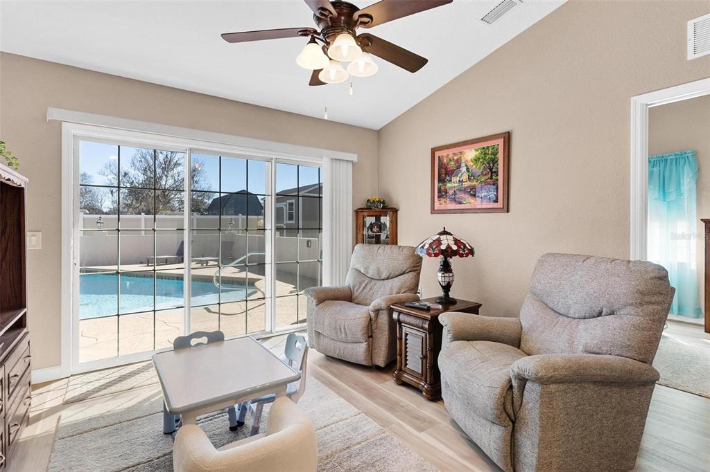 450 Northeast 55th Street Ocala, FL 34479 - Photo 49 of 68 a living room with furniture a ceiling fan and a window