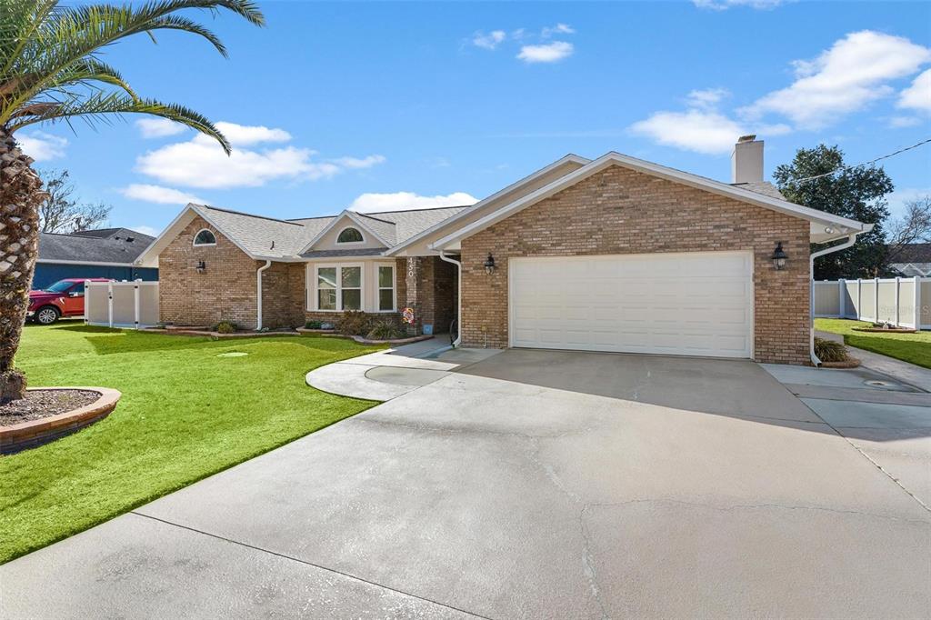 450 Northeast 55th Street Ocala, FL 34479 - Photo 5 of 68 a view of a white house with a yard plants and large tree