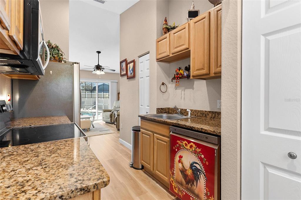 450 Northeast 55th Street Ocala, FL 34479 - Photo 52 of 68 a kitchen with stainless steel appliances granite countertop a stove a sink and a refrigerator