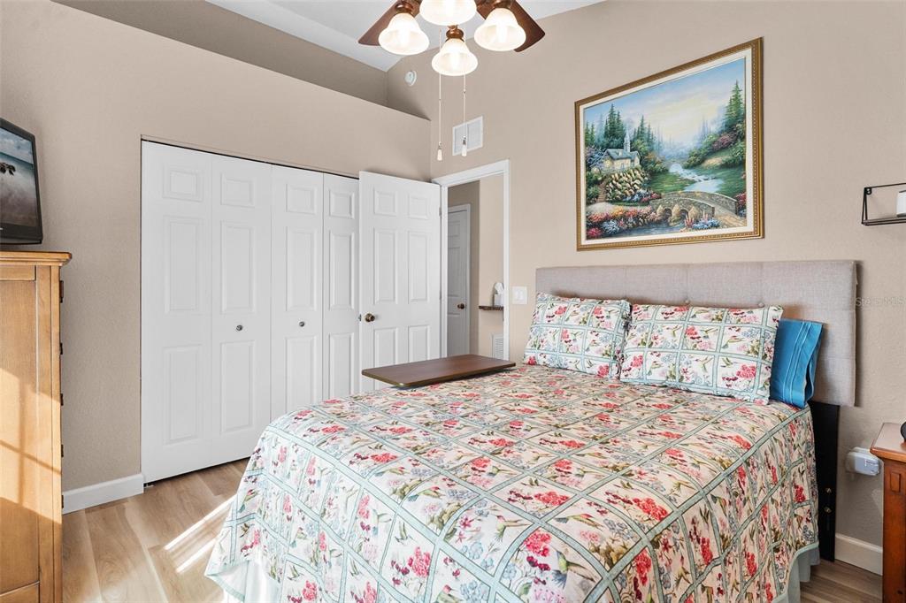 450 Northeast 55th Street Ocala, FL 34479 - Photo 54 of 68 a bedroom with a large bed and a chandelier