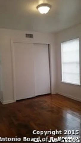 an empty room with wooden floor