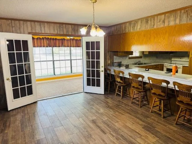 a view of kitchen and dining room with furniture window and wooden floor
