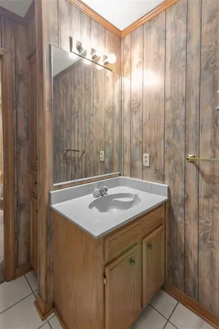 a bathroom with a granite countertop sink and a shower
