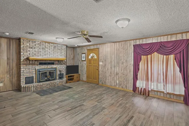 a view of a livingroom with a fireplace and window