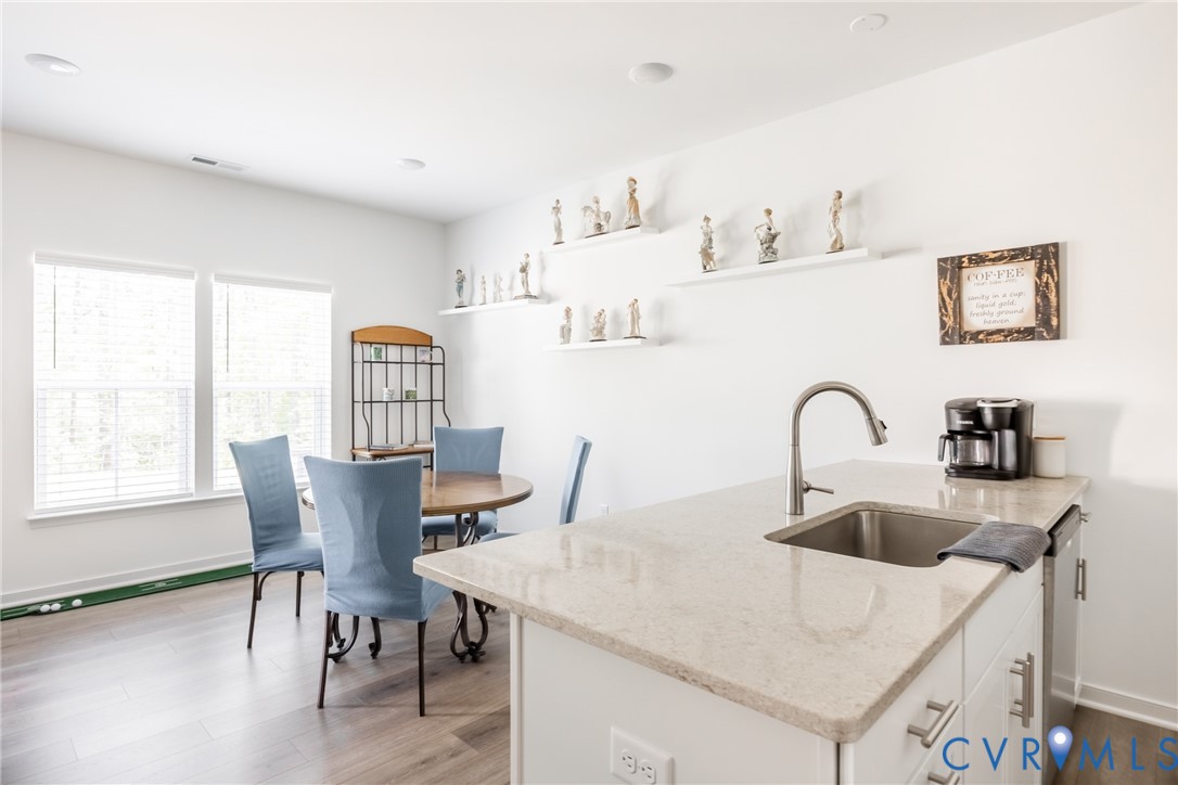 11309 Benton Pointe Way Chester, VA 23831 - Photo 11 of 32 a kitchen with stainless steel appliances a table and chairs in it