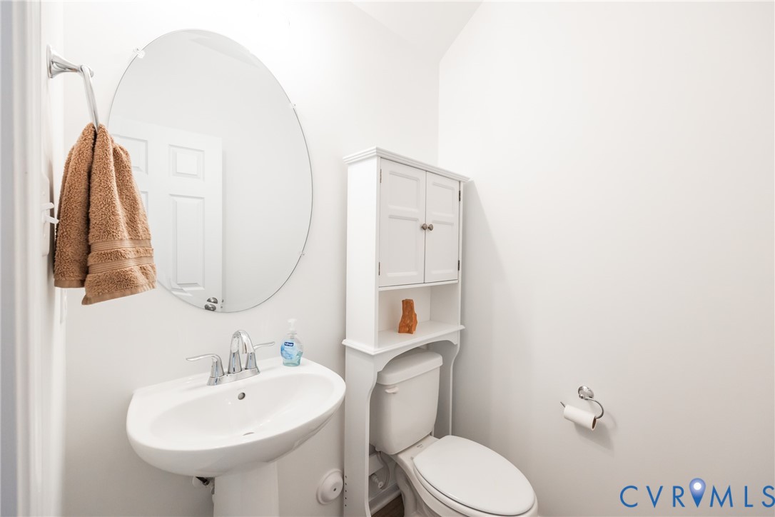 11309 Benton Pointe Way Chester, VA 23831 - Photo 14 of 32 a bathroom with a sink a toilet and a mirror
