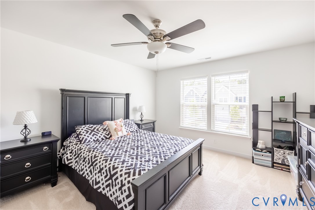 11309 Benton Pointe Way Chester, VA 23831 - Photo 16 of 32 a bedroom with a bed and a table