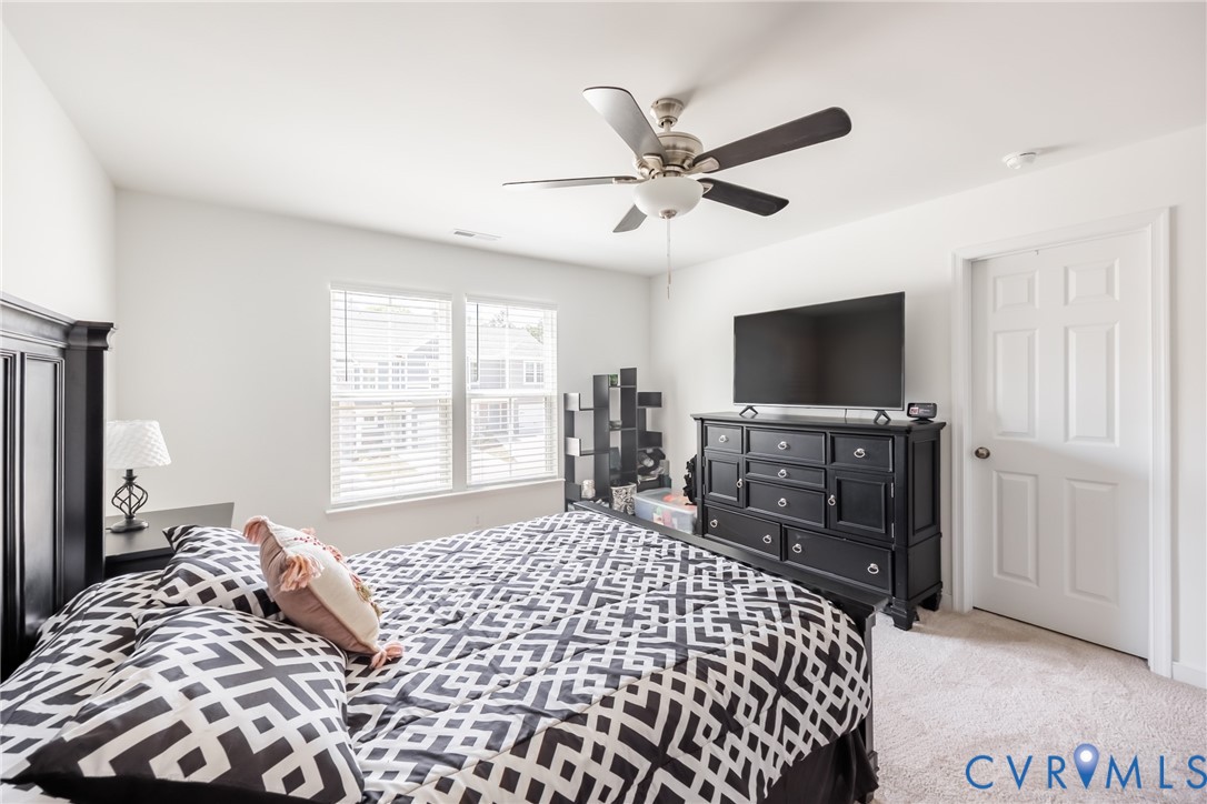 11309 Benton Pointe Way Chester, VA 23831 - Photo 17 of 32 a bedroom with a bed and a flat screen tv