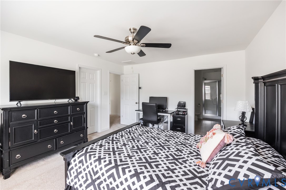 11309 Benton Pointe Way Chester, VA 23831 - Photo 18 of 32 a bedroom with a bed and a flat screen tv