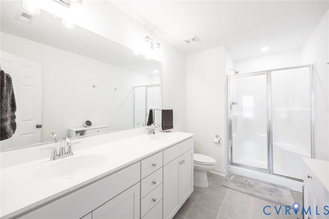 11309 Benton Pointe Way Chester, VA 23831 - Photo 19 of 32 a bathroom with a sink a toilet and shower