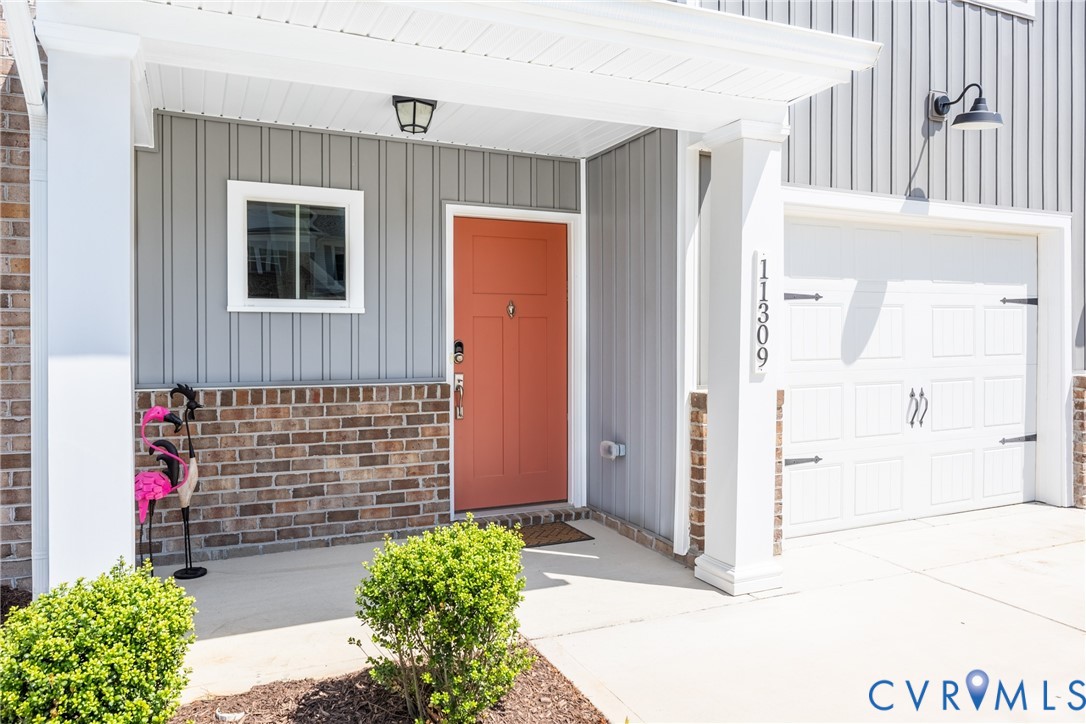 11309 Benton Pointe Way Chester, VA 23831 - Photo 2 of 32 a front view of a house with a garage
