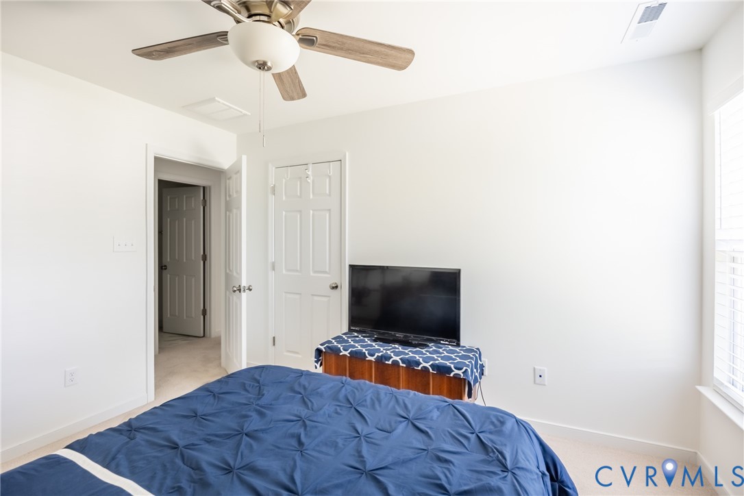 11309 Benton Pointe Way Chester, VA 23831 - Photo 22 of 32 a bedroom with a bed and a flat screen tv