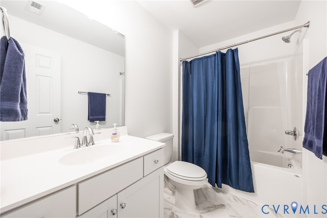 11309 Benton Pointe Way Chester, VA 23831 - Photo 25 of 32 a bathroom with a sink a toilet a mirror and shower