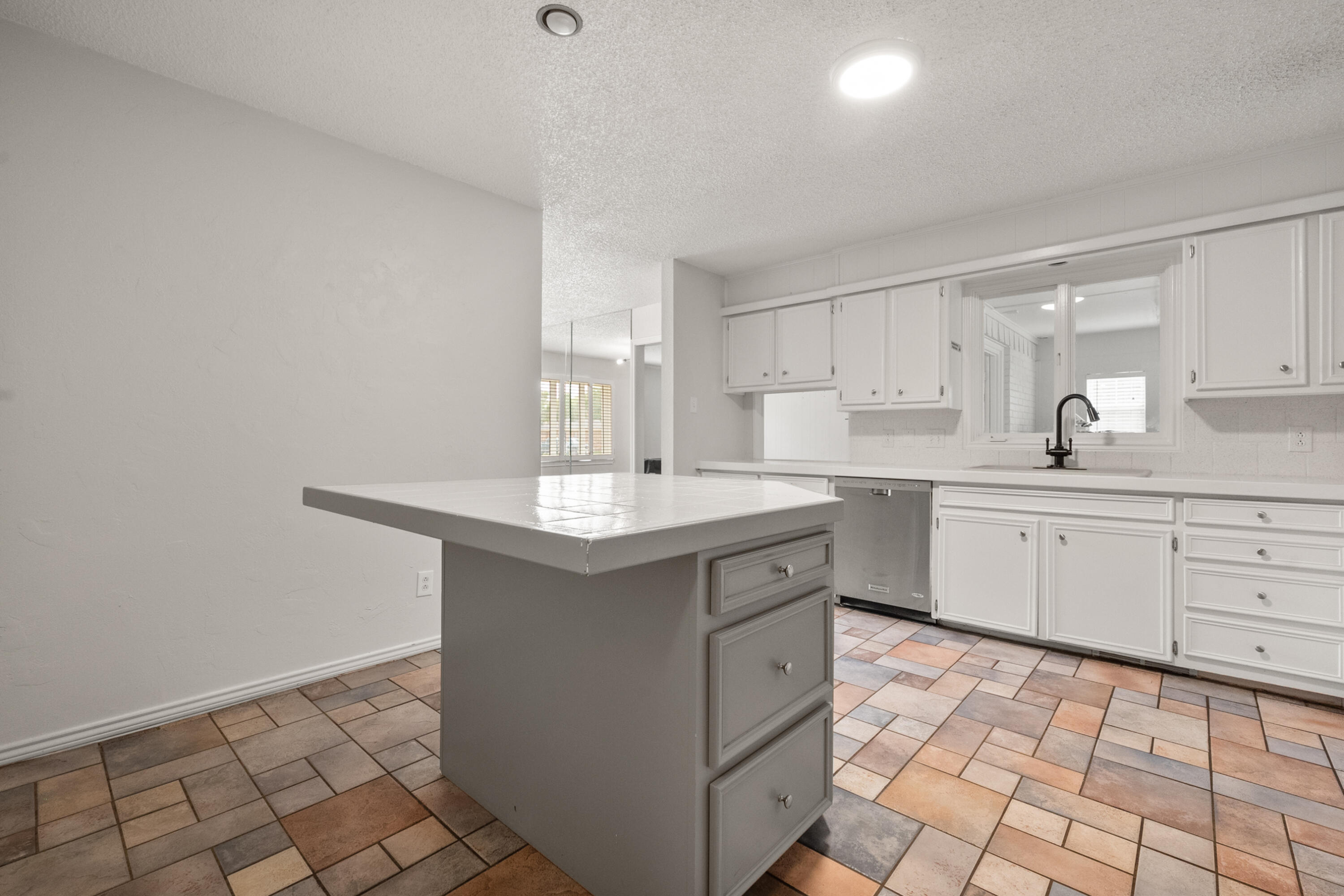 4523 79th Street Lubbock, TX 79424 - Photo 14 of 33 a kitchen with a sink cabinets and window