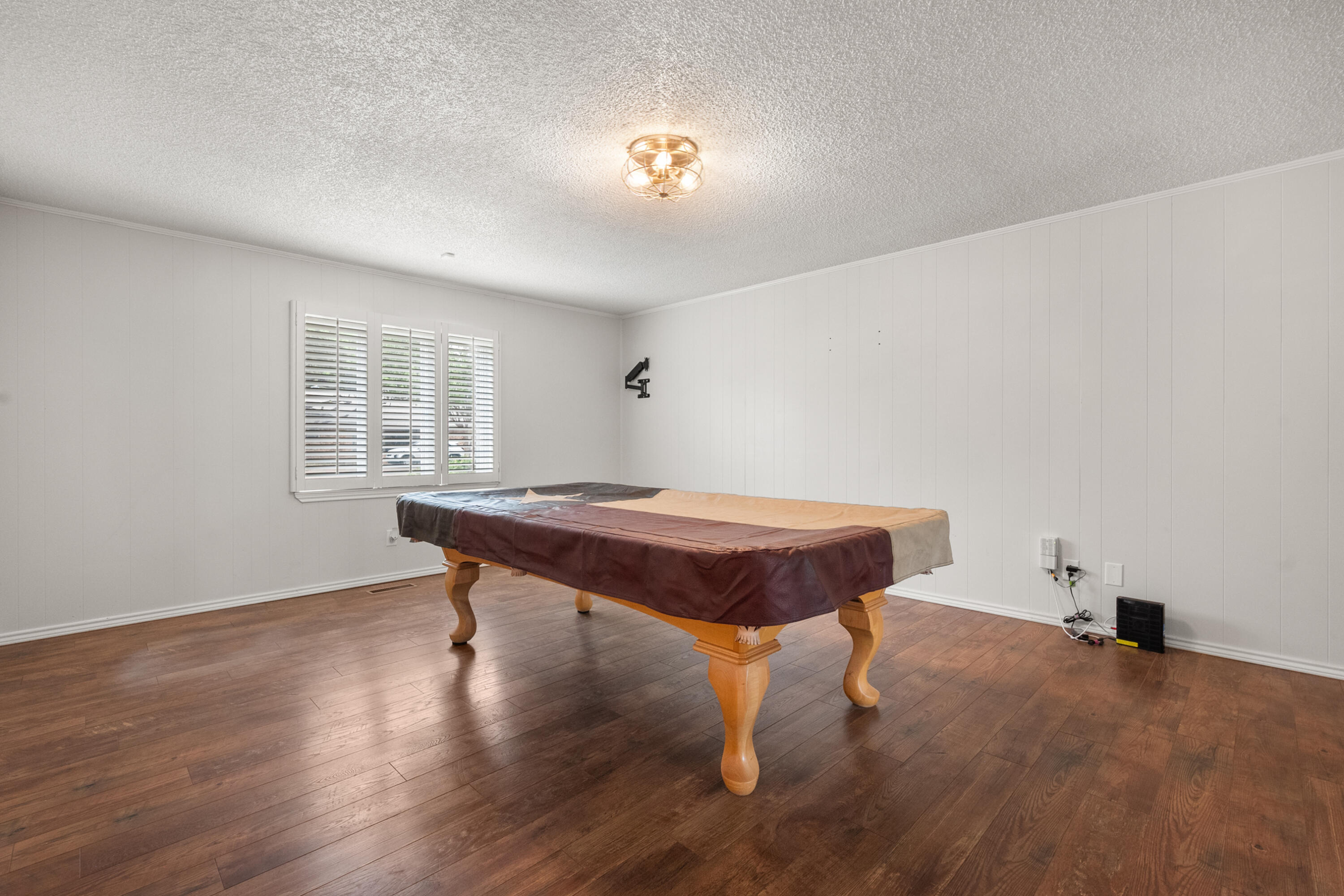 4523 79th Street Lubbock, TX 79424 - Photo 18 of 33 a room with pool table wooden floor and windows