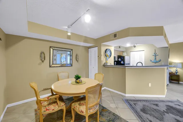 a view of a dining room with furniture and a potted plant