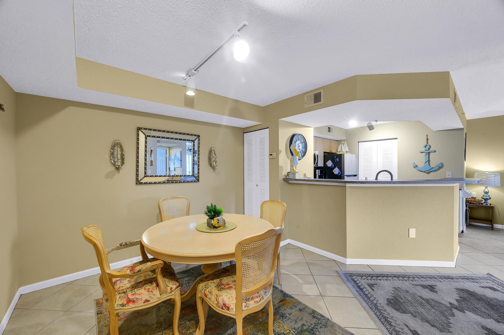 3670 Northwest Adriatic Lane Jensen Beach, FL 34957 - Photo 1 of 26 a view of a dining room with furniture and a potted plant