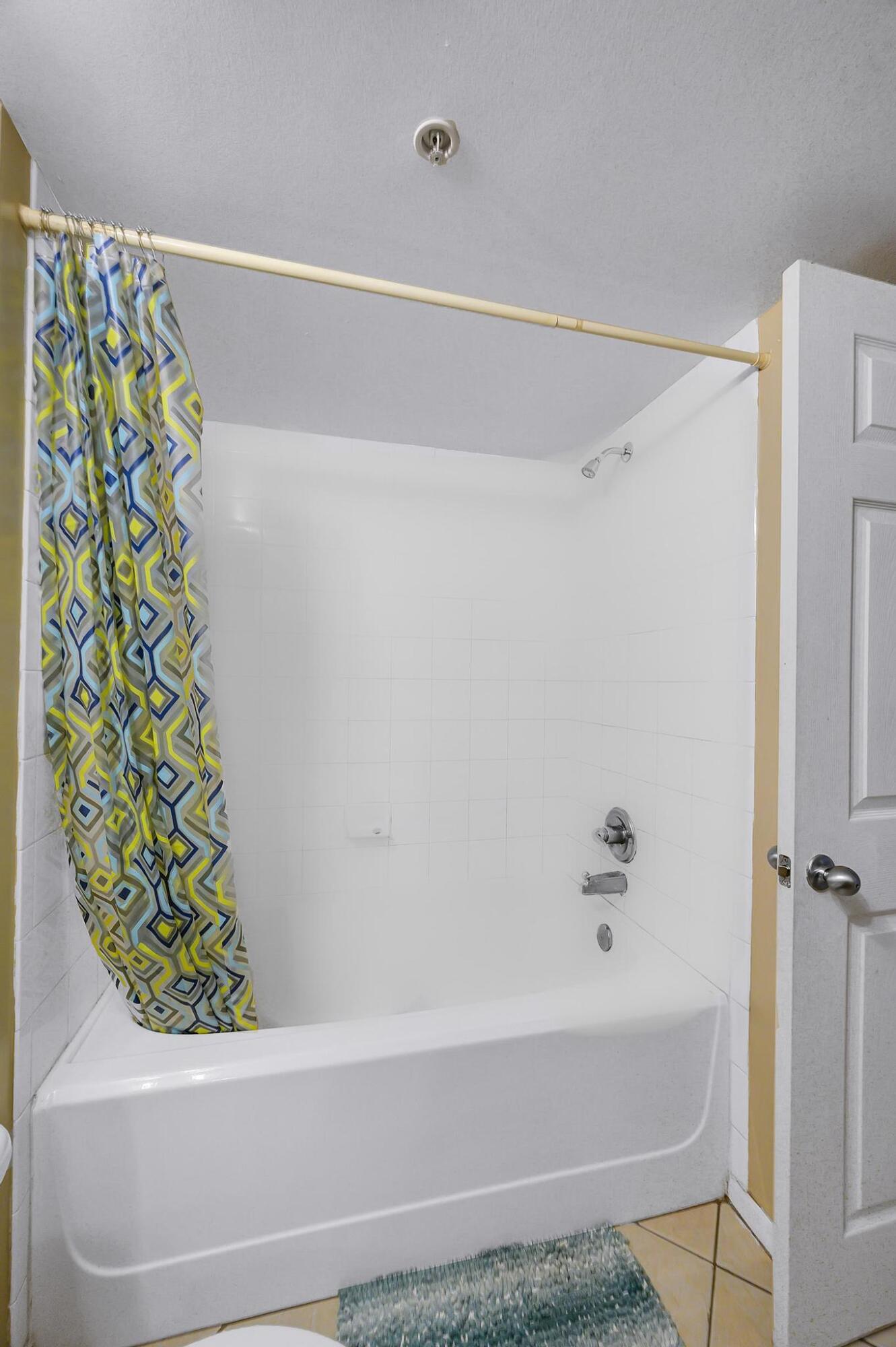 3670 Northwest Adriatic Lane Jensen Beach, FL 34957 - Photo 14 of 26 a bathroom with a bathtub and shower