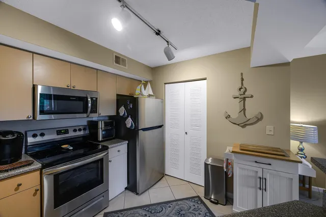 a kitchen with stainless steel appliances a stove a refrigerator and cabinets
