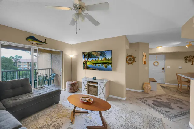 a living room with furniture a rug and a large window