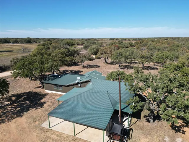 a view of a terrace with lawn chairs