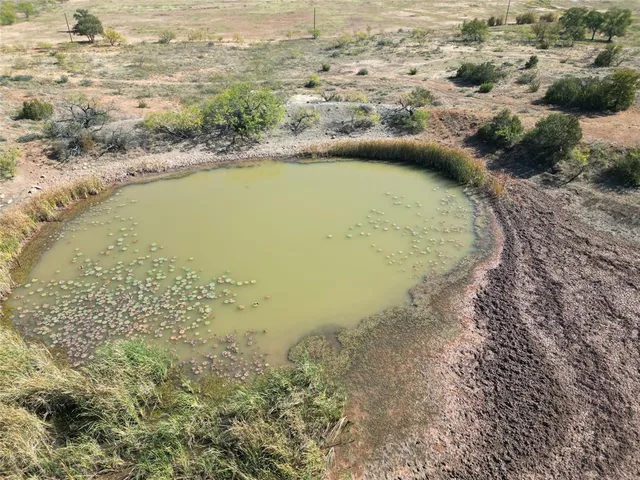 an aerial view of a houses with beach