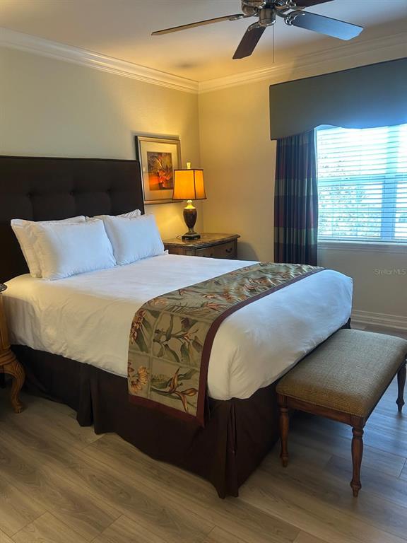 Undisclosed Address Reunion, FL 34747 - Photo 3 of 29 a bedroom with a bed two lamps and a large window with outer view