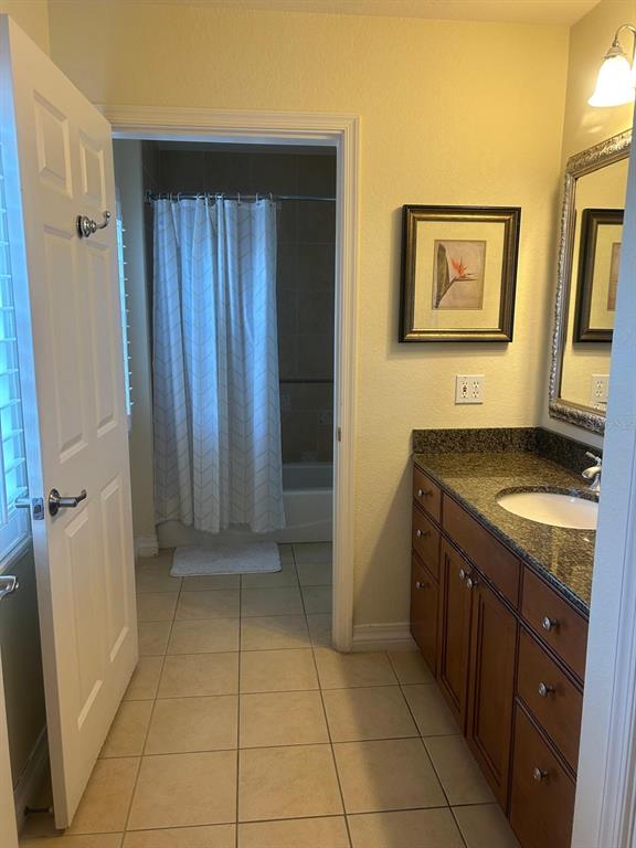 Undisclosed Address Reunion, FL 34747 - Photo 4 of 29 a bathroom with a granite countertop sink a toilet and a mirror
