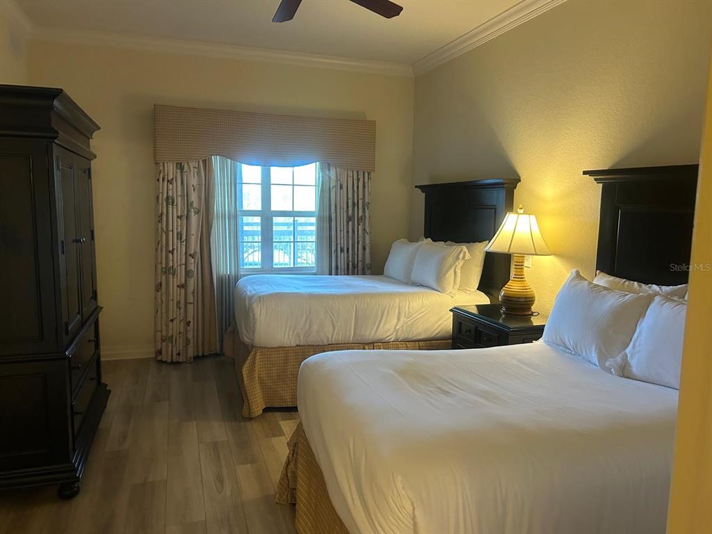 Undisclosed Address Reunion, FL 34747 - Photo 6 of 29 a bedroom with two beds and a flat screen tv