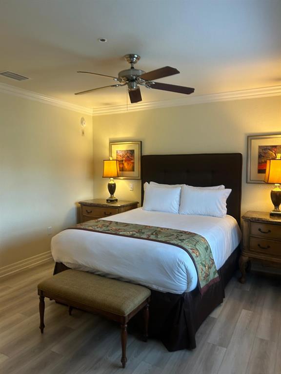 Undisclosed Address Reunion, FL 34747 - Photo 7 of 29 a bedroom with a bed and wooden floor