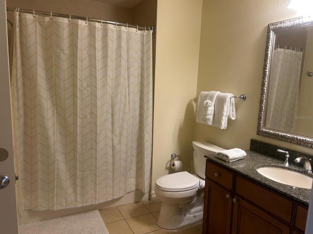 Undisclosed Address Reunion, FL 34747 - Photo 10 of 29 a bathroom with a granite countertop sink toilet and a mirror