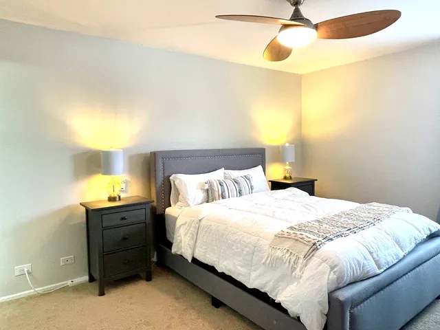 a bedroom with a bed and a chandelier