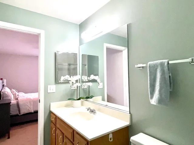 a en suite bathroom with a sink and mirror