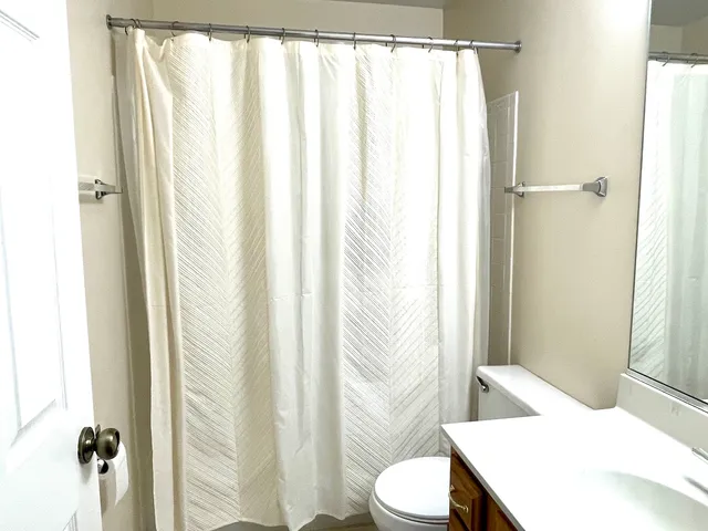 a bathroom with a toilet a sink and a shower