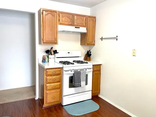 a kitchen with a stove and a white cabinet