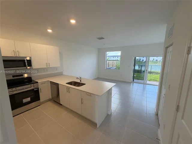 a kitchen with a stove and a refrigerator