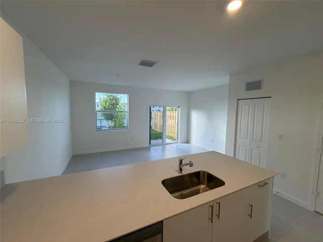a kitchen with a sink and a window