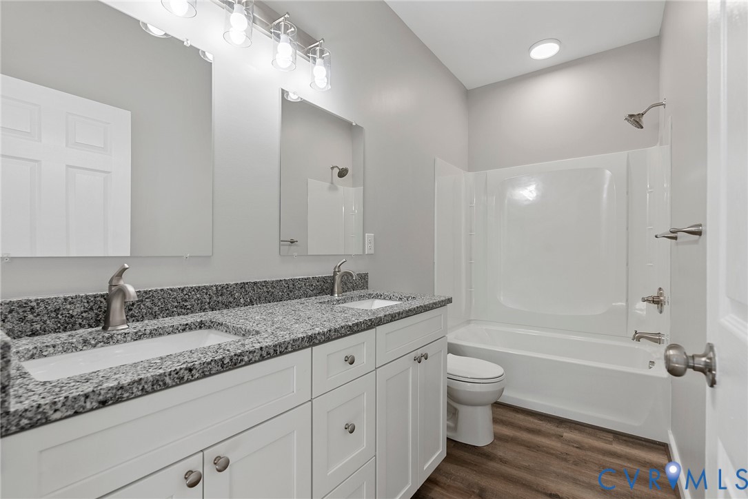 2768 Venter Road Aylett, VA 23009 - Photo 15 of 31 a bathroom with a granite countertop sink a toilet and bathtub