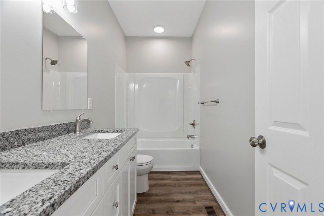 2768 Venter Road Aylett, VA 23009 - Photo 16 of 31 a bathroom with a granite countertop sink a toilet and shower