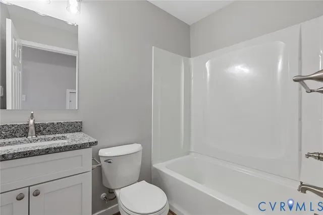 a white toilet sitting next to a bath tub