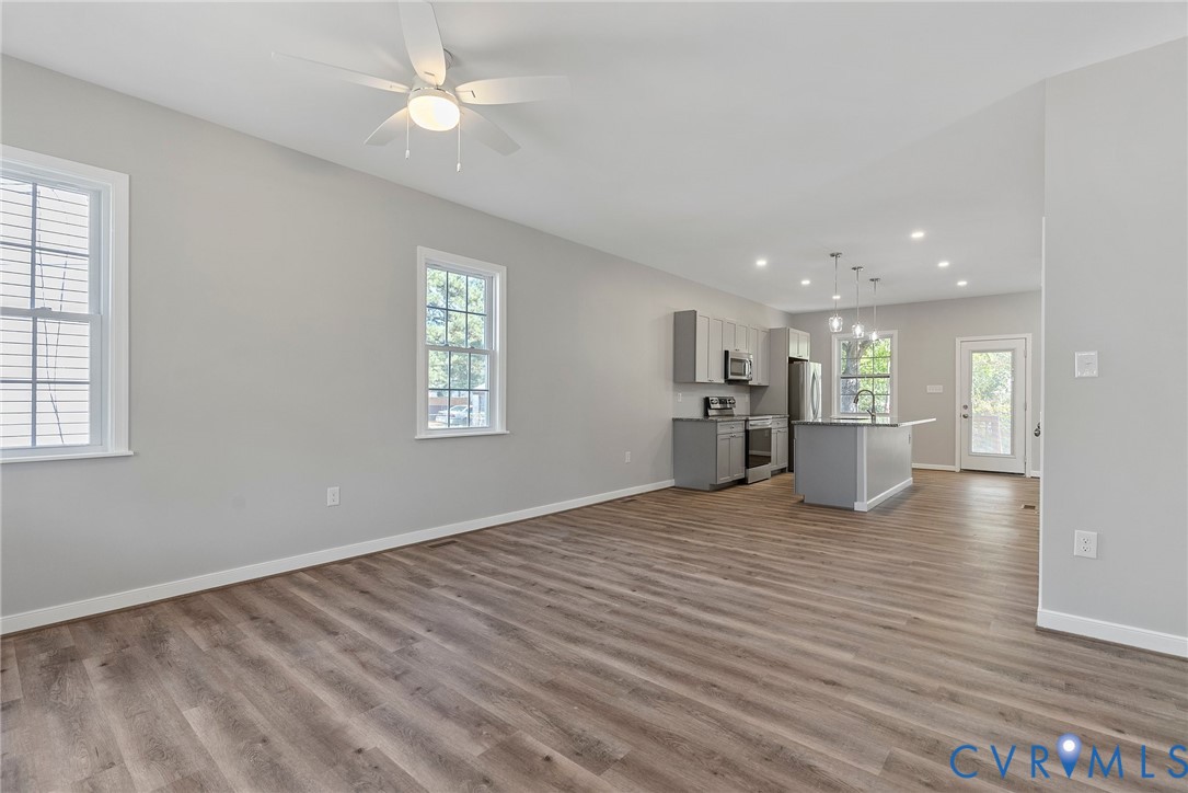 2768 Venter Road Aylett, VA 23009 - Photo 5 of 31 a view of empty room with wooden floor and kitchen view